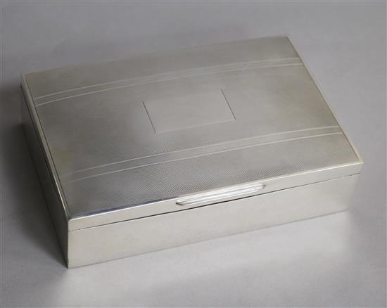 A 1960s engine turned silver rectangular cigarette box, Birmingham, 1964, 17cm.